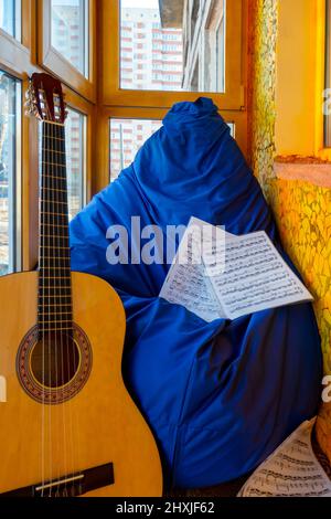 Composition with guitar and sheet music on balcony  Stock Photo