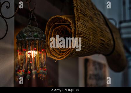 In Andalucia it is typical to place lights at entrance of houses, wicker blind is used to protect from sun. Stock Photo