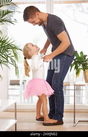 Getting down with my little princess. Full length shot of a father and daughter dancing. Stock Photo