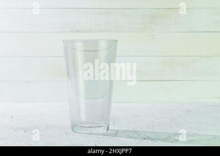 Empty glass beaker on a white background. Glassware and background with space for text Stock Photo