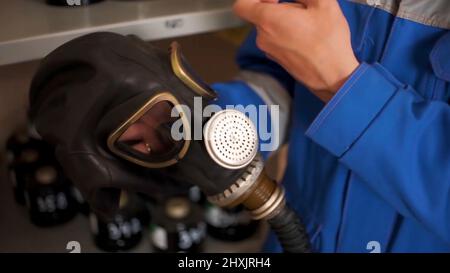 Checking gas masks. Clip. Testing of new gas masks in the workflow at factories Stock Photo