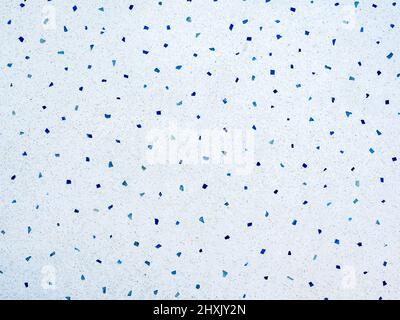 Terrazzo wall background. Cement wall texture ornamented with many small pieces of blue stone. Stock Photo