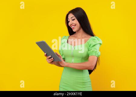 Cheerful young woman using tablet at studio Stock Photo