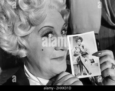 Mrs Slocombe (Actress Molly Sugden) seen here showing off her passport photograph for a Grace Brothers staff trip to Spain in the film of the tv series 'Are You Being Serve?'  July 5th 1977 *** Local Caption *** Watscan -  - 02/07/2009 Stock Photo