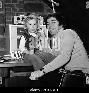 Disc Jockey Tony Blackburn and his son Simon, 3, in their private recording studio in the garden of their home near Maidenhead, Berkshire. 10th February 1976. Stock Photo