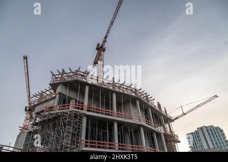 cranes above a shell made of reinforced concrete Stock Photo
