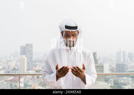 Portrait of young African Muslim man wearing religious clothing an scarf Stock Photo