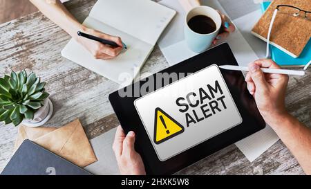Scam alert detecting warning. Notification on device screen. Stock Photo