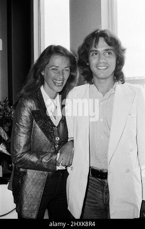 Jean Michel Jarre, currently with a number two album 'Oxygene' in the British charts and with a top ten single 'Oxygene', pictured at Heathrow airport from Paris with his girlfriend, British actress, Charlotte Rampling. They will be here for a week to promote 'Oxygene'. 5th September 1977. Stock Photo