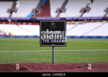 London, UK. 13th Mar, 2022. Please keep off the grass sign. Premier League match, West Ham Utd v Aston Villa at the London Stadium, Queen Elizabeth Olympic Park in London on Sunday 13th March 2022. this image may only be used for Editorial purposes. Editorial use only, license required for commercial use. No use in betting, games or a single club/league/player publications. pic by Steffan Bowen/Andrew Orchard sports photography/Alamy Live news Credit: Andrew Orchard sports photography/Alamy Live News Stock Photo