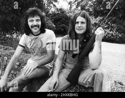 Members of Heavy Metal group Black Sabbath relaxing  in the scenic Wye Valley.Tony Iommi and Ozzy Osbourne (holding a gun) 10th August, 1977 Stock Photo