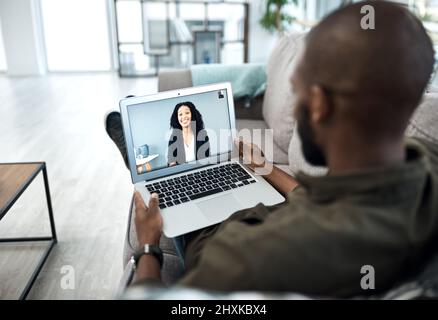 Working from home is here to stay. Shot of a young businessman having a video call with his colleague while working from home. Stock Photo