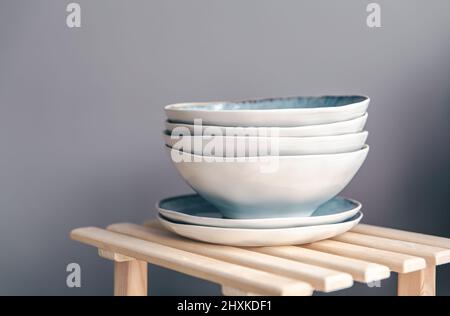 A set of beautiful plates in pastel colors on a gray background. Stock Photo
