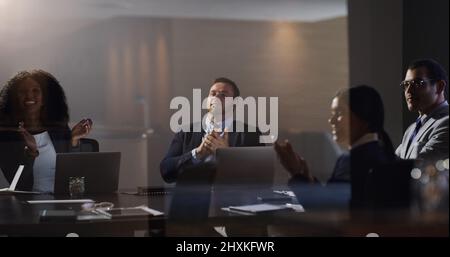 We succeed and grow as a team. Shot of a group of businesspeople clapping during a meeting in a boardroom. Stock Photo