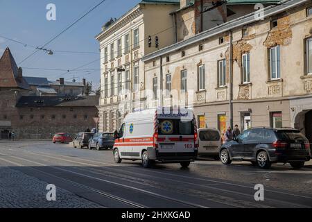 An ambulance is seen dashing down in Lviv city centre. Civilians in Lviv try to live their daily life despite this morning Russian bomb attack on a military base outside Lviv. Stock Photo