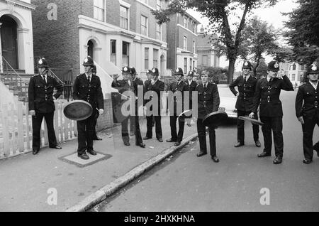 Battle of Lewisham, South London, Saturday 13th August 1977. National Front rally from New Cross to Lewisham is disrupted by counter demonstrations and leads to violent clashes with Police Officers and anti racism demonstrators. Pictured, Police Officers use dustbin lids for protection, riot shields are also used for the first time on UK streets. Stock Photo