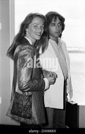 Jean Michel Jarre, currently with a number two album 'Oxygene' in the British charts and with a top ten single 'Oxygene', pictured at Heathrow airport from Paris with his girlfriend, British actress, Charlotte Rampling. They will be here for a week to promote 'Oxygene'. 5th September 1977. Stock Photo