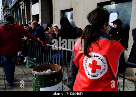 Brussels, Belgium. 13th Mar, 2022. Members of Red Cross outside an immigration office in Brussels, Belgium on March 13, 2022. Credit: ALEXANDROS MICHAILIDIS/Alamy Live News Stock Photo