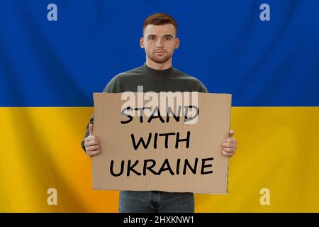 Young man holding banner with inscription stand with Ukraine, collage Stock Photo