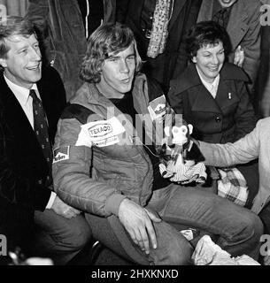 James Hunt, the new World Motor Racing Champion, received a hero's welcome when he flew into Heathrow Airport this morning from Japan.  The 29-year-old McLaren Formula One driver was greeted by most of his family and girlfriend Jane Birbeck. Picture shows James speaking to the media.  His father Wallis Hunt, is sitting to Jame's right. His mother Sue Hunt is sitting to his left in the dark coat. Behind and out of shot are his sister Georgina, Sally and brother - in - law Philip Jones (married to Sally) sit behind. (not 100% id'd as left to rights apart from Philip Jones)  Picture taken 26th Oc Stock Photo