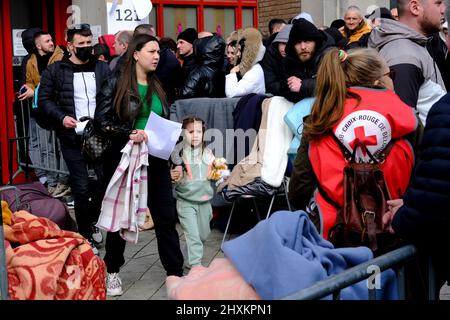 Brussels, Belgium. 13th Mar, 2022. Members of Red Cross outside an immigration office in Brussels, Belgium on March 13, 2022. Credit: ALEXANDROS MICHAILIDIS/Alamy Live News Stock Photo