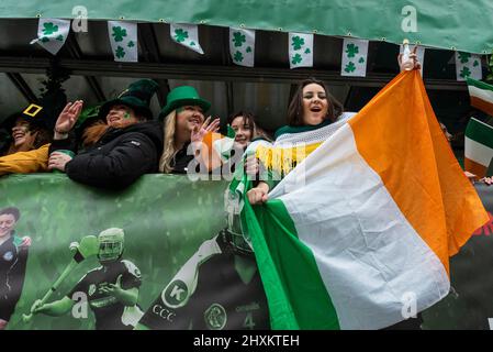 London, UK.  13 March 2022.  People on a float during the annual St Patrick’s Day parade in central London, which returns after being postponed due to the Covid-19 pandemic.  Key workers from across London are Grand Marshals at the event, in recognition of their work during the pandemic.  Credit: Stephen Chung / Alamy Live News Stock Photo