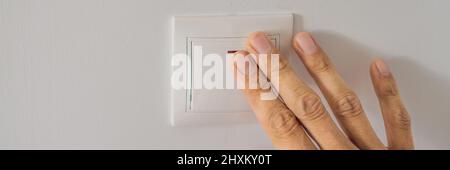 Master electrician installs a socket in the house BANNER, LONG FORMAT Stock Photo