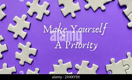 Motivational and inspirational quote on missing jigsaw puzzle - Make yourself a priority. Motivational concept Stock Photo