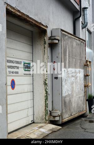 Old blast door on a city street in Bodo, Norway. Stock Photo