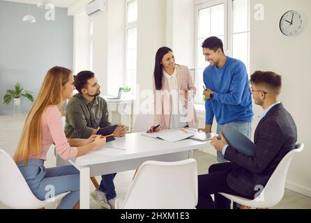 Successful marketing team working together on new startup project in modern bright office. Stock Photo