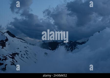 moving clouds against snow covered peaks seen from Edelweissspitze towards Hohe Tauern, Grossglockner national park, Fuschertal side, Austria Stock Photo