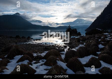 afternoon sun seen from Seewiese with fog rising from lake and Sarstein mountain in background Stock Photo