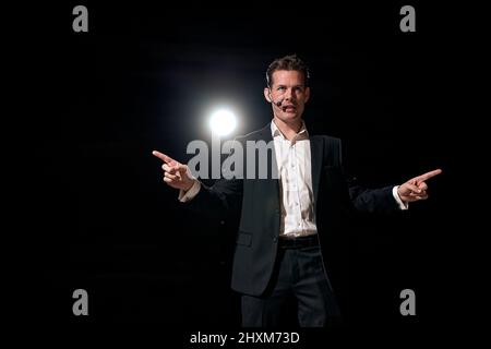 successful man with microphone speaking at corporate business coaching and training auditorium conference room talking giving motivation training from Stock Photo