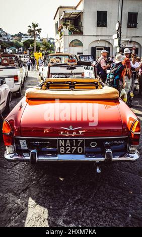 One of the iconic open top red taxis of Capri, Stock Photo