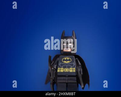 Tambov, Russian Federation - March 11, 2022 A Lego Batman minifigure standing against a blue background. Close up. Stock Photo