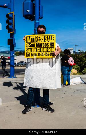 High school fund raiser mattress sale at a street corner for San Marcos High School in Santa Barbara County, Calfornia. Stock Photo