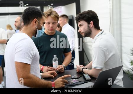 DUBAI, UAE, 13th March 2022. Exhibitors interact at the Dubai WOW (World of Web3) Summit. This event is a leading gathering of senior decision-makers discussing the impact of blockchain and associated technologies on financial services Stock Photo