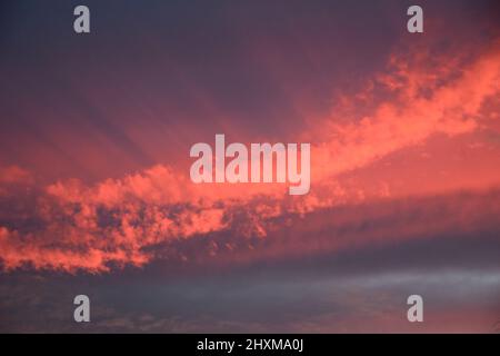 Shapes and patterns in the clouds set ablaze by the setting sun. Stock Photo