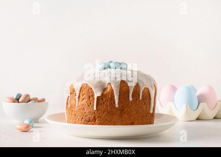 Easter orthodox cake decorated blue eggs on white background. Holidays traditional dessert. Christian custom. Stock Photo