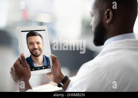 Black man doctor having video call with patient Stock Photo