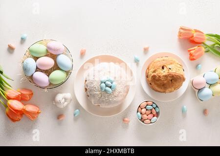 Easter orthodox cakes, chocolate and colourful eggs on white background. View from above. Christian custom. Banner. Festive morning. Stock Photo