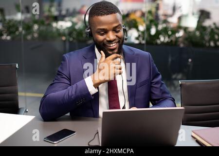 Handsome black manager having video interview with employee Stock Photo