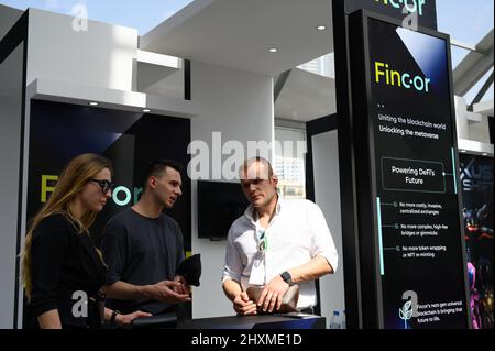 DUBAI, UAE, 13th March 2022. Exhibitors interact at the Dubai WOW (World of Web3) Summit is . This event is a leading gathering of senior decision-makers discussing the impact of blockchain and associated technologies on financial services Stock Photo