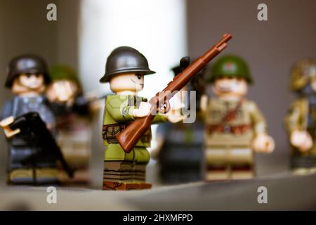Kyiv, Ukraine. March 9, 2022. Military man with machine gun. LEGO Second World War soldiers. Toy soldier in camouflage uniform with weapon. Troops. Wa Stock Photo