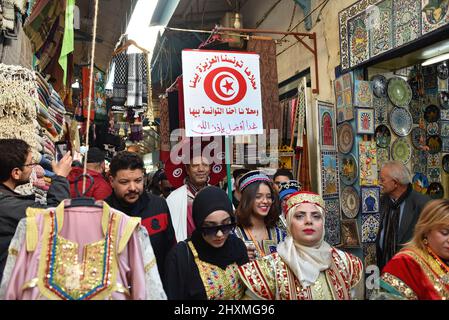 Tunis, Tunisia. 13th Mar, 2022. People wearing traditional clothes take part in a march during the National Day of Traditional Dress organized by Tunisia Heritage Association in Tunis. Every year in March, Tunisians commemorate their history by wearing their traditional dress to ensure that their past is not forgotten. This year participants began the march from Madrasa Slimania towards the Statue of Ibn Khaldun. Credit: SOPA Images Limited/Alamy Live News Stock Photo