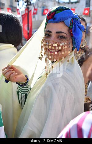 Tunis, Tunisia. 13th Mar, 2022. A Tunisian woman, dressed in traditional clothes takes part in a march during the National Day of Traditional Dress, organized by Tunisia Heritage Association in Tunis. Every year in March, Tunisians commemorate their history by wearing their traditional dress to ensure that their past is not forgotten. This year participants began the march from Madrasa Slimania towards the Statue of Ibn Khaldun. (Photo by Jdidi Wassim/SOPA Images/Sipa USA) Credit: Sipa USA/Alamy Live News Stock Photo