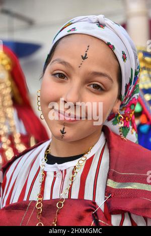 Tunis, Tunisia. 13th Mar, 2022. A Tunisian woman, dressed in traditional clothes takes part in a march during the National Day of Traditional Dress, organized by Tunisia Heritage Association in Tunis. Every year in March, Tunisians commemorate their history by wearing their traditional dress to ensure that their past is not forgotten. This year participants began the march from Madrasa Slimania towards the Statue of Ibn Khaldun. (Photo by Jdidi Wassim/SOPA Images/Sipa USA) Credit: Sipa USA/Alamy Live News Stock Photo