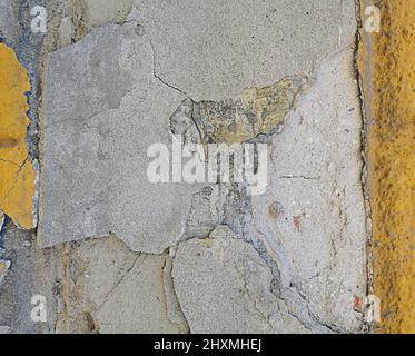 peeling plaster on a painted wall  Stock Photo