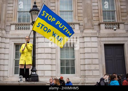 London, UK. 13th Mar, 2022. Protester holds a flag during the demonstration. Hundreds of demonstrators gathered in Whitehall, central London to protest against Russia's assault on Ukraine. Credit: SOPA Images Limited/Alamy Live News Stock Photo