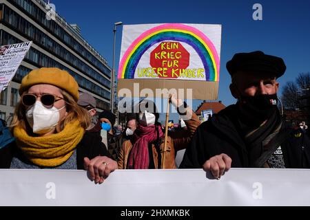 Berlin, Berlin, Germany. 13th Mar, 2022. Protesters can be seen as tens of thousands people rally under the slogan ''Stop the war. Peace and solidarity for the people of Ukraine'' from Alexanderplatz to the StraÃŸe des 17 Juni in Central Berlin. (Credit Image: © Jan Scheunert/ZUMA Press Wire) Stock Photo